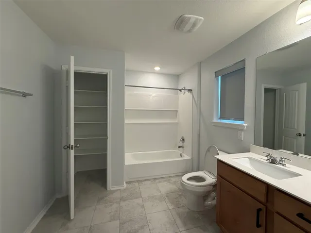a bathroom with a sink a toilet and vanity