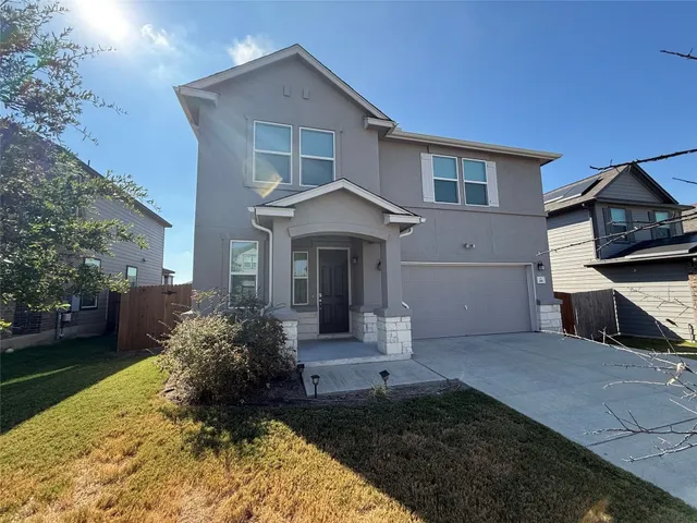 a kitchen with kitchen island granite countertop a refrigerator stove top oven and sink