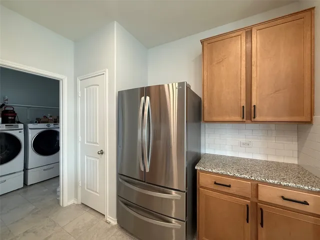 a view of an empty room with a window and fireplace