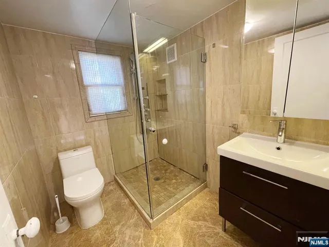 a bathroom with a toilet sink and shower