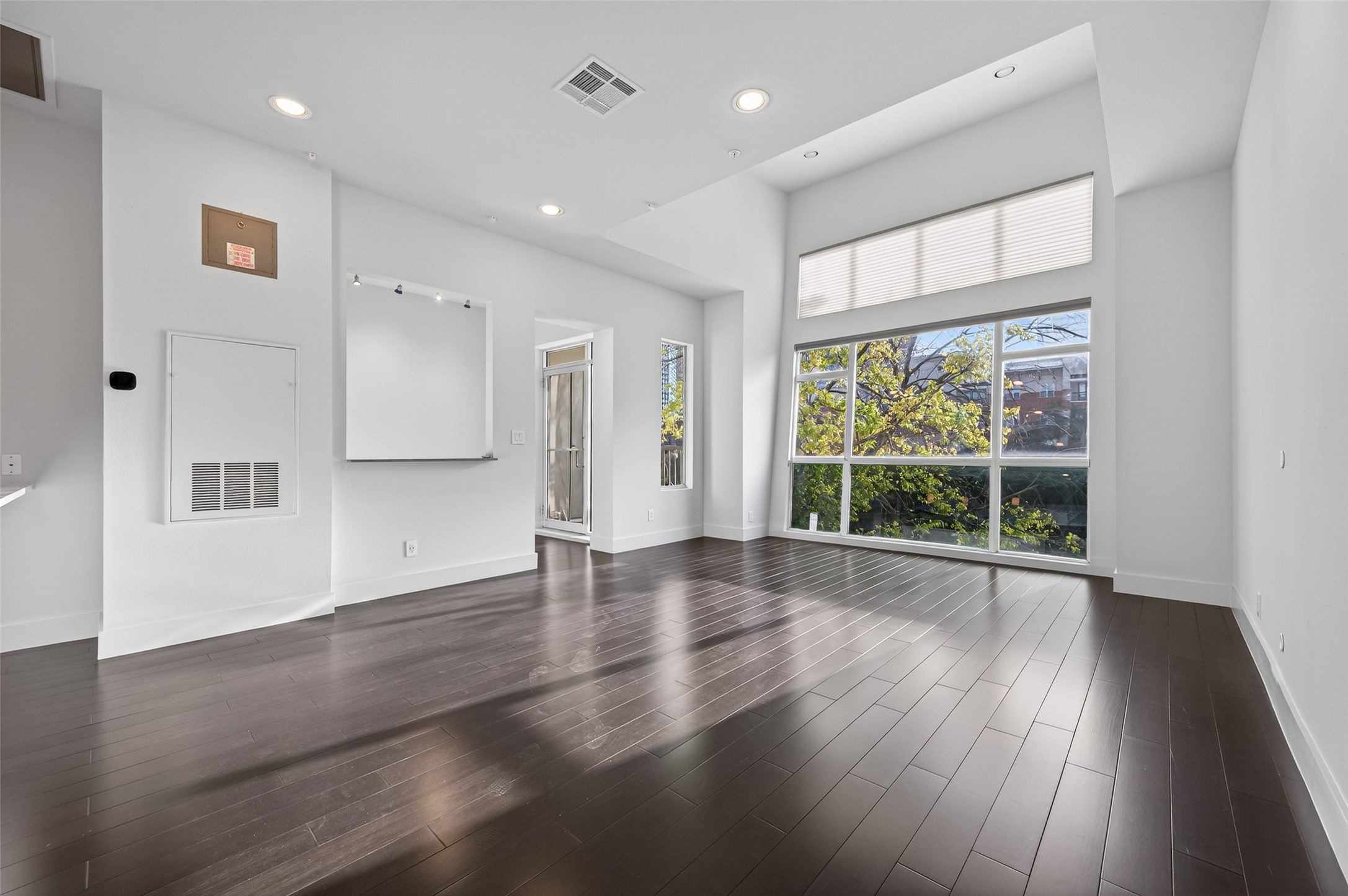 207 Pierce Street, Unit 307 Houston, TX 77002 - Photo 3 of 33 Beautiful wall of windows with motorized blinds anchors the living space!