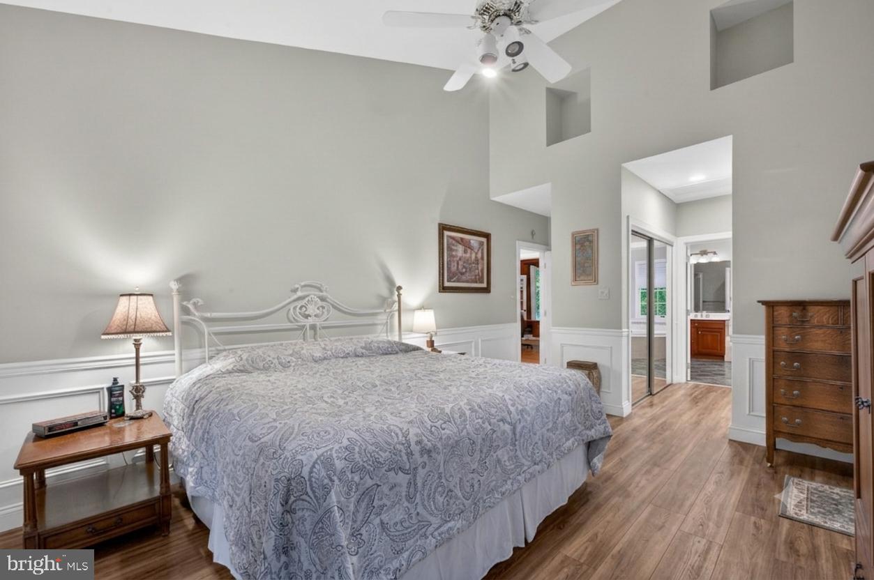 6601 Colchester Road Fairfax Station, VA 22039 - Photo 41 of 78 a spacious bedroom with a bed and a chandelier
