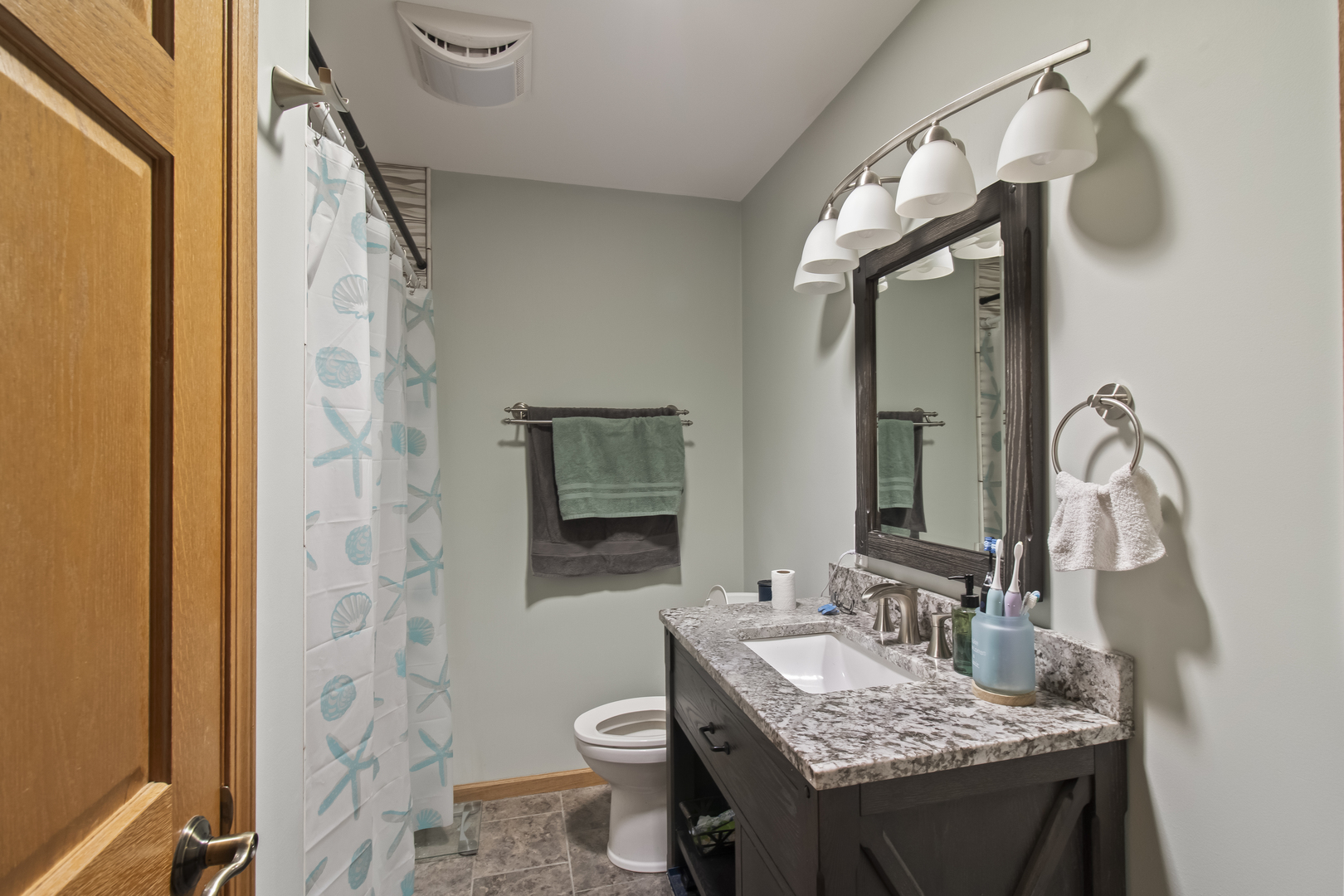 812 West 3rd Street Gilman, IL 60938 - Photo 15 of 19 a bathroom with a granite countertop sink vanity mirror and toilet