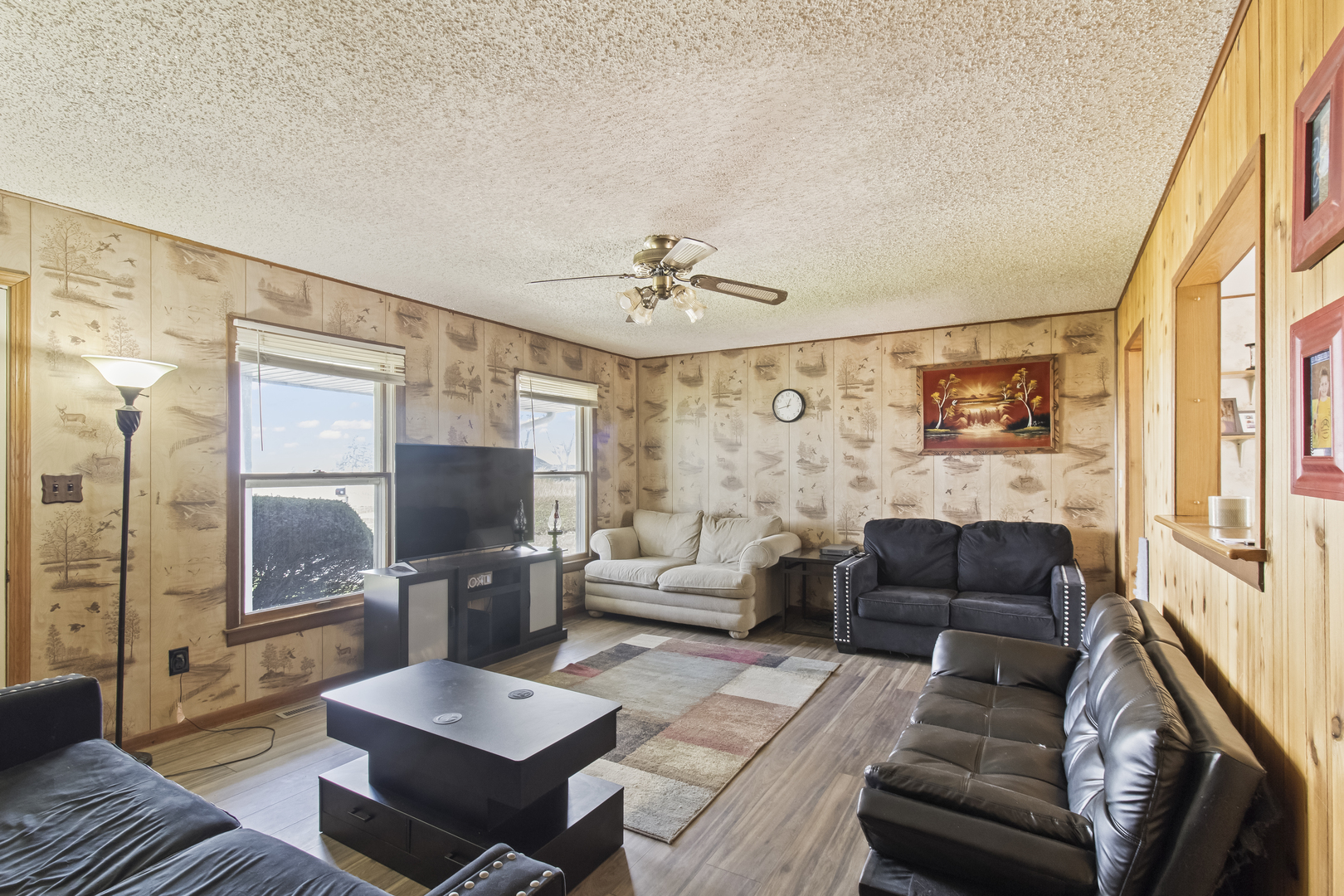 812 West 3rd Street Gilman, IL 60938 - Photo 3 of 19 a living room with furniture a large window and a flat screen tv