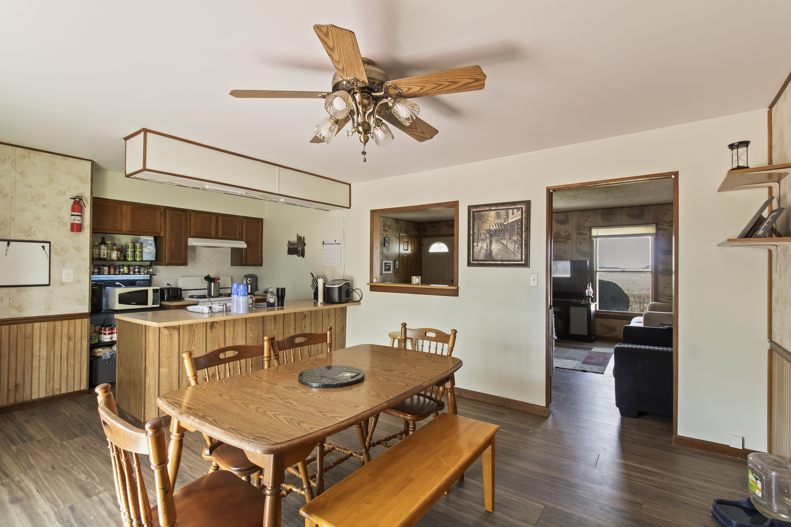 812 West 3rd Street Gilman, IL 60938 - Photo 7 of 19 a living room with stainless steel appliances kitchen island granite countertop furniture wooden floor and a kitchen view