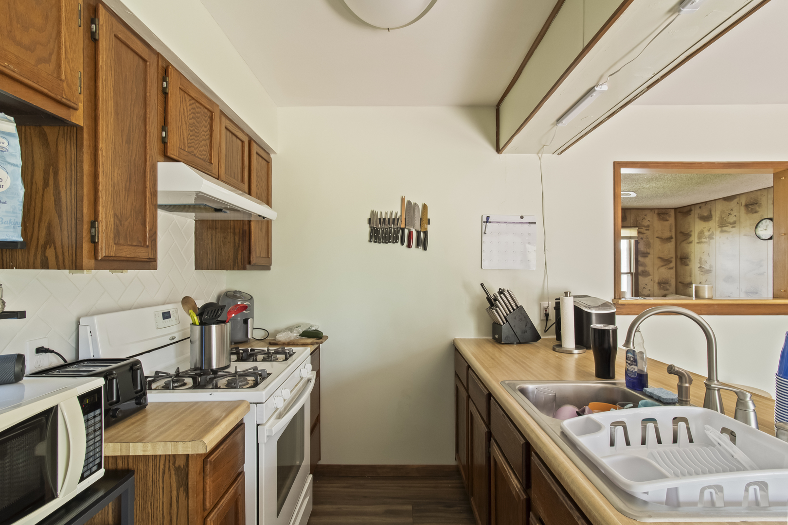 812 West 3rd Street Gilman, IL 60938 - Photo 8 of 19 a kitchen with stainless steel appliances granite countertop a stove a sink dishwasher and cabinets with wooden floor