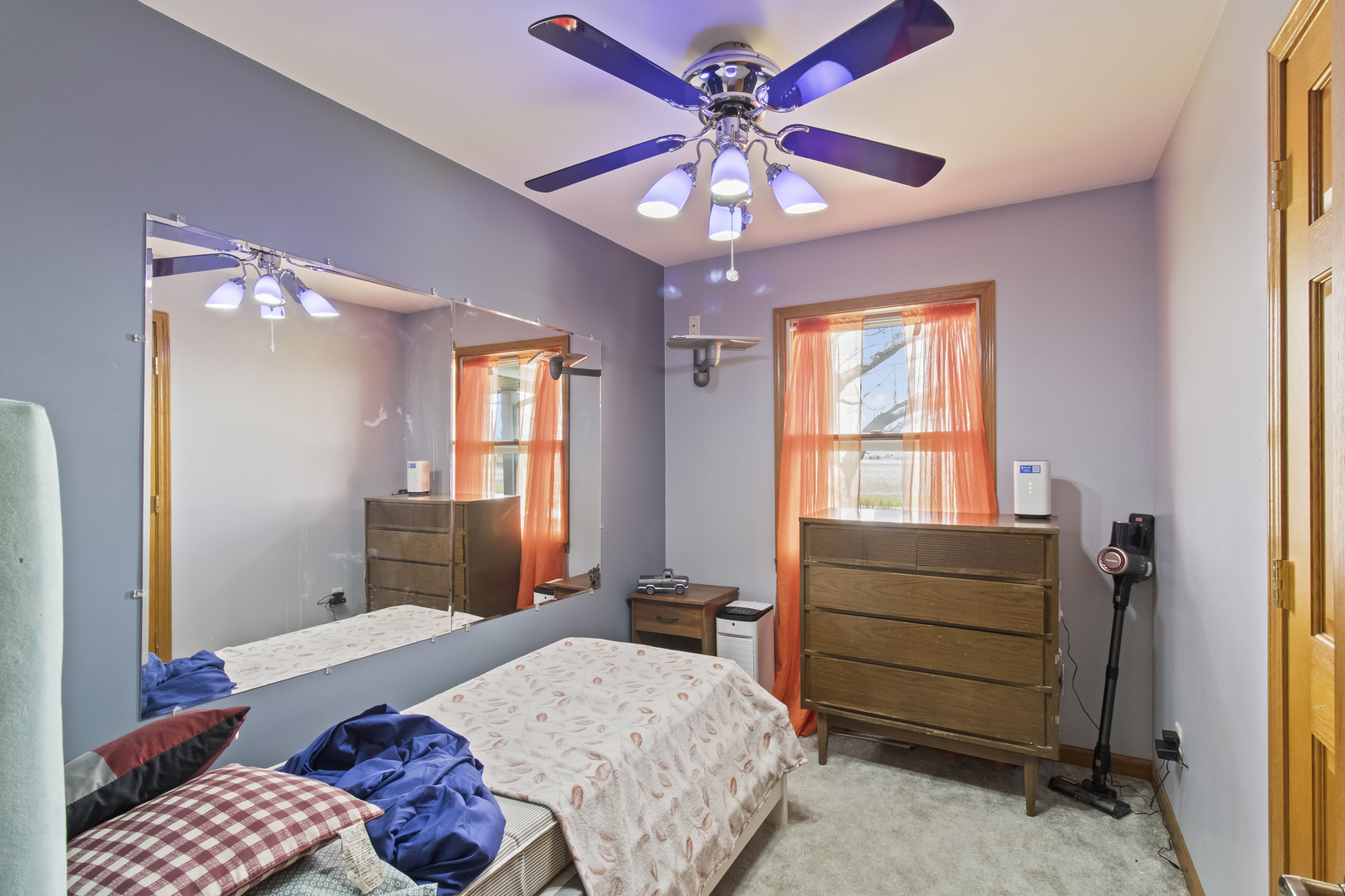 812 West 3rd Street Gilman, IL 60938 - Photo 9 of 19 a bedroom with a bed and a chandelier