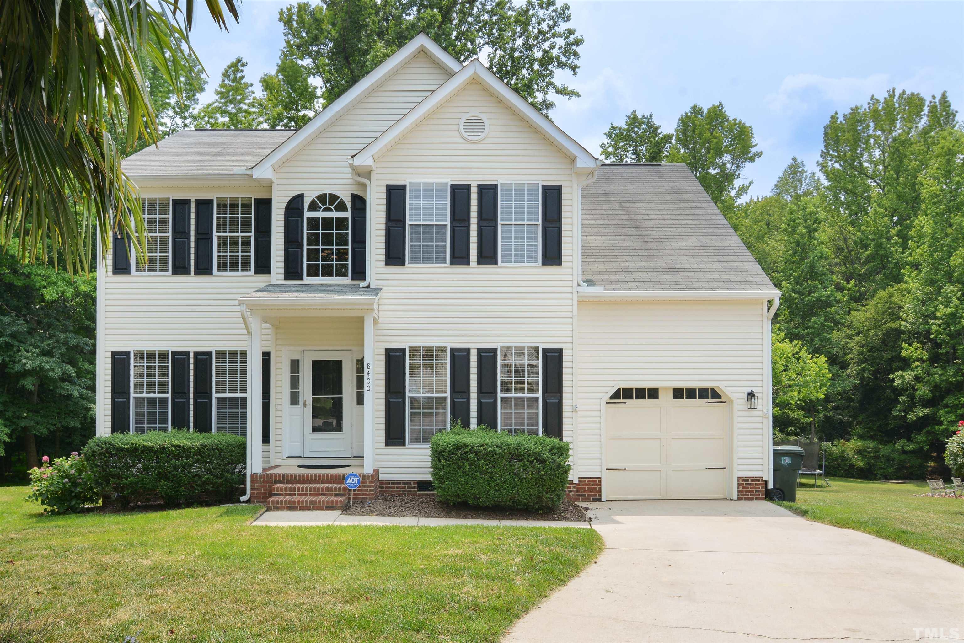 8400 Astwell Court Raleigh, NC 27615 - Photo 1 of 21 a front view of a house with a yard and garage
