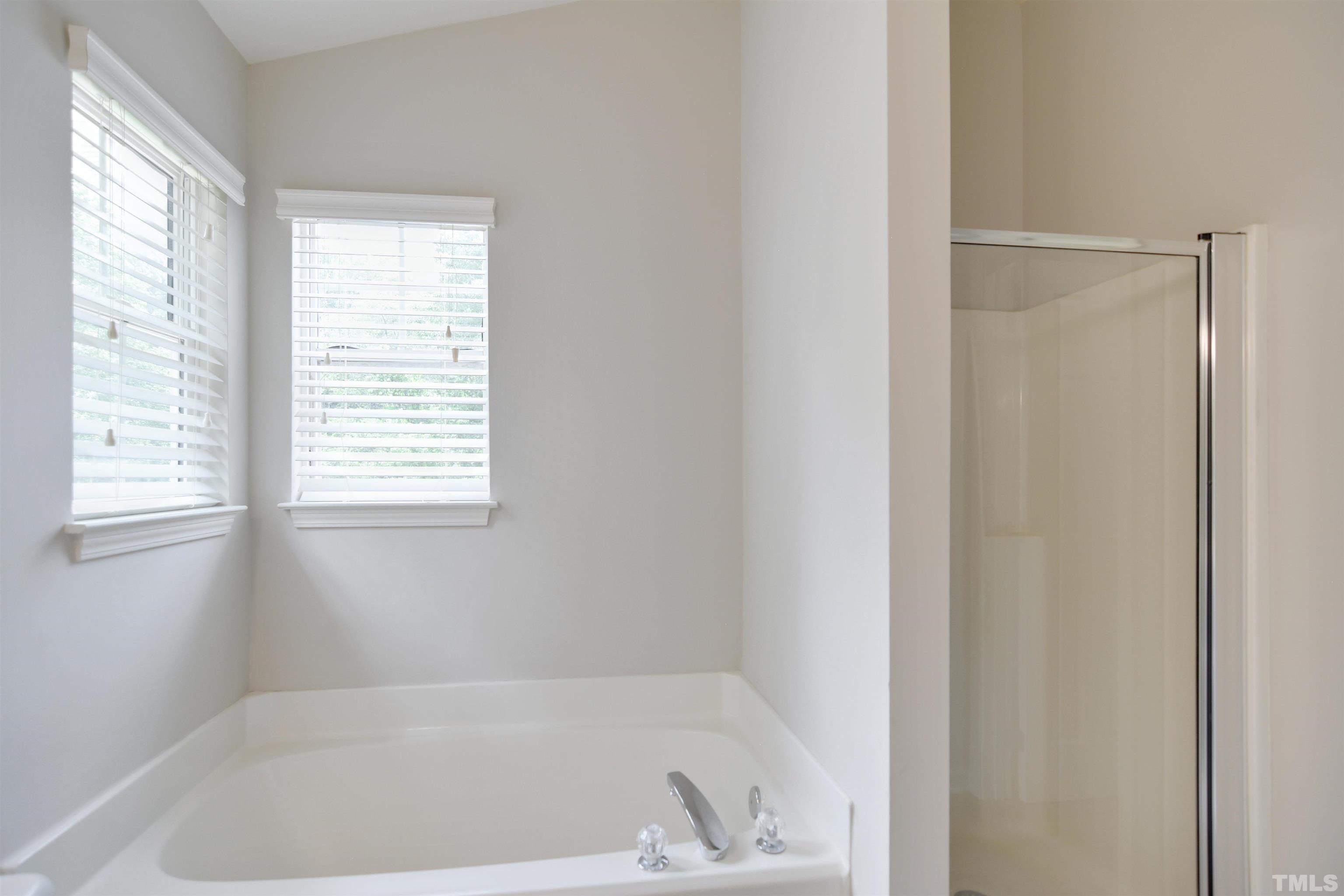 8400 Astwell Court Raleigh, NC 27615 - Photo 14 of 21 a white bath tub sitting next to a window