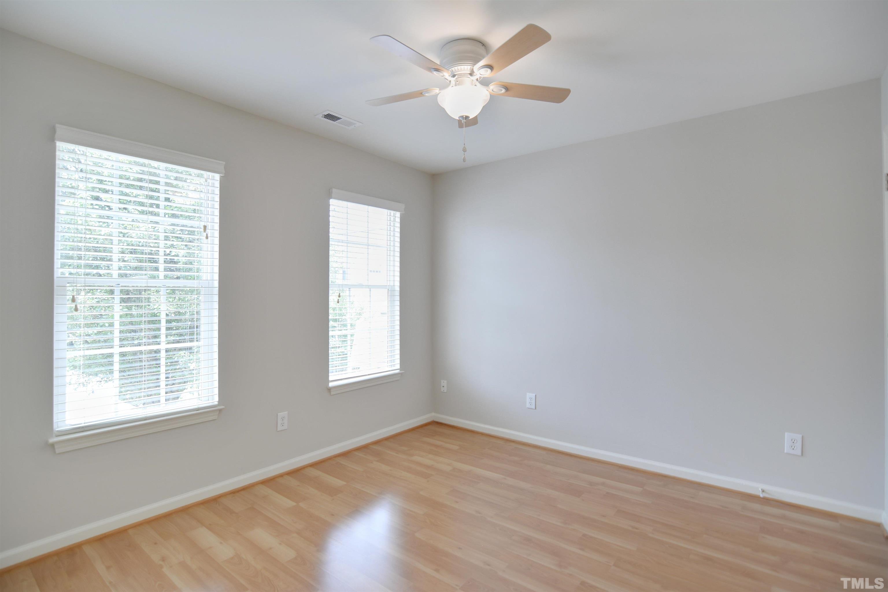 8400 Astwell Court Raleigh, NC 27615 - Photo 15 of 21 wooden floor in an empty room with a window