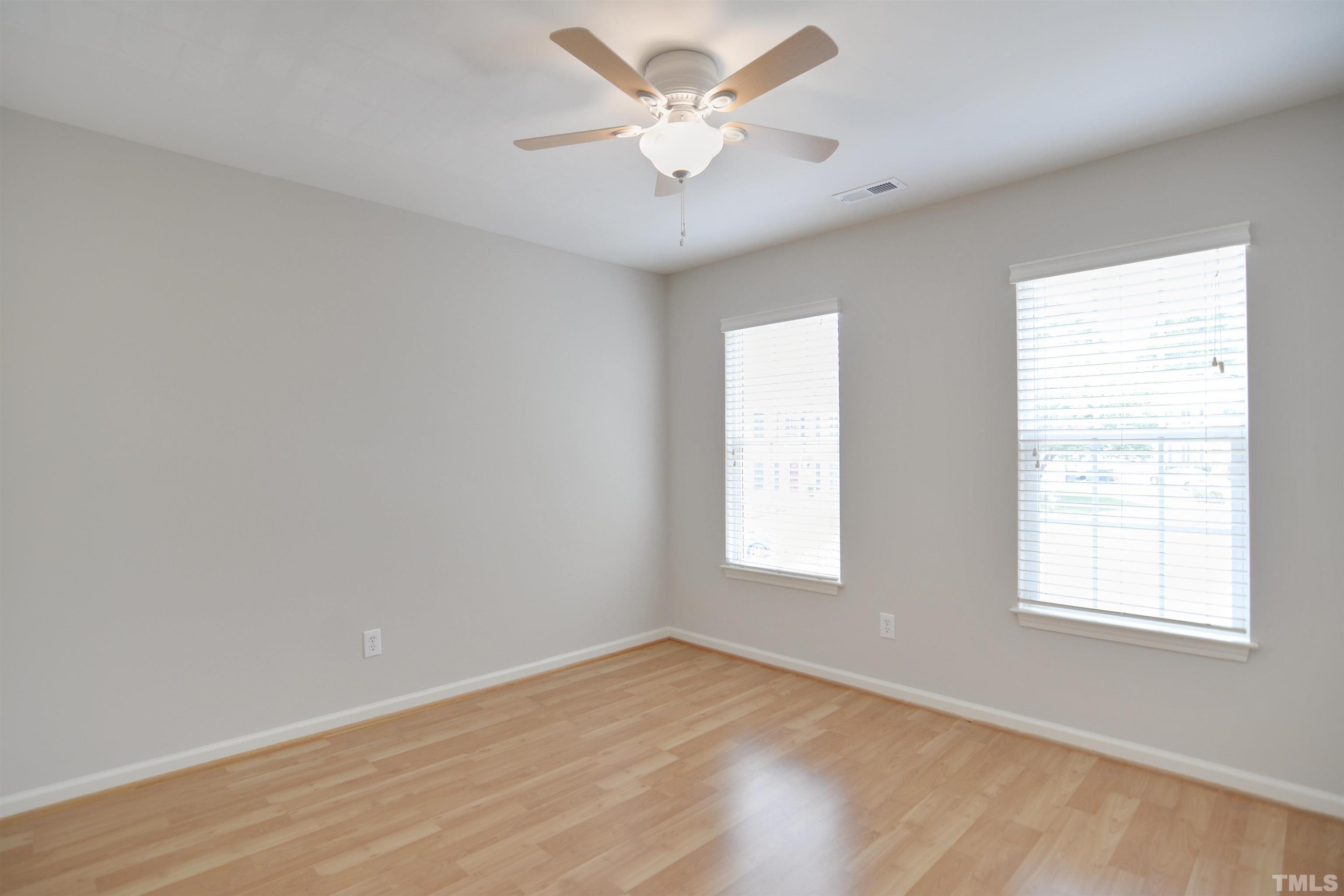 8400 Astwell Court Raleigh, NC 27615 - Photo 16 of 21 an empty room with a window and a ceiling fan
