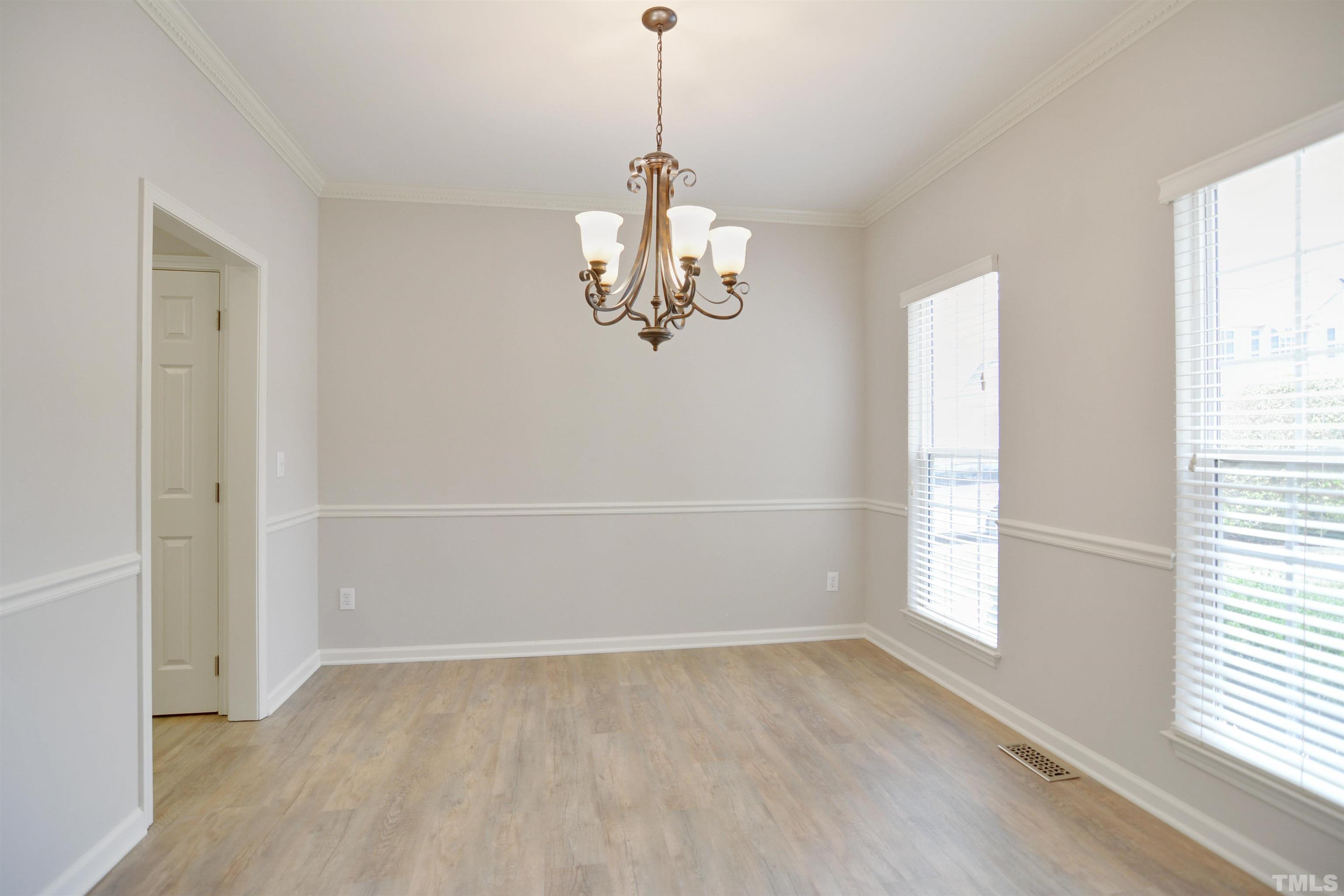 8400 Astwell Court Raleigh, NC 27615 - Photo 2 of 21 wooden floor in an empty room with a window