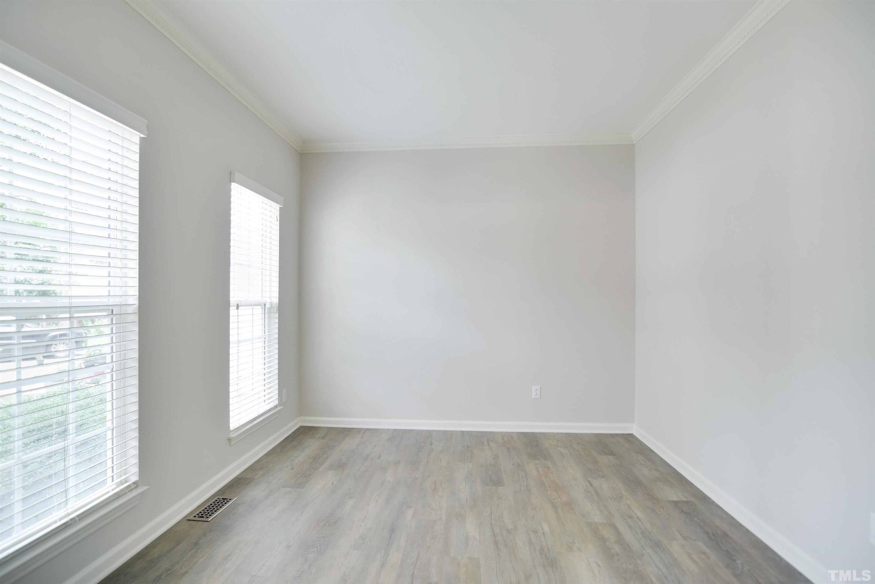 8400 Astwell Court Raleigh, NC 27615 - Photo 3 of 21 an empty room with wooden floor and windows