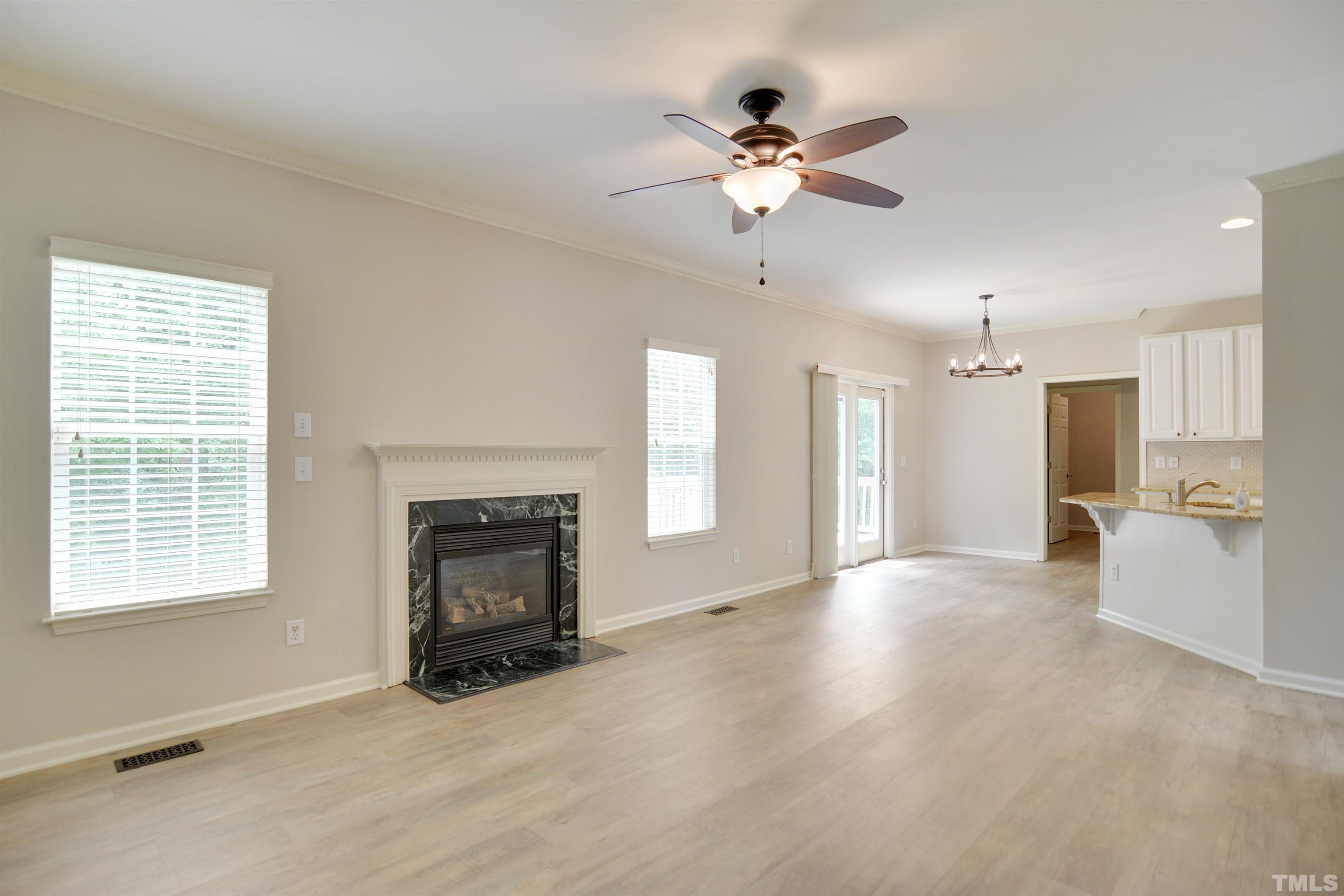 8400 Astwell Court Raleigh, NC 27615 - Photo 6 of 21 a view of an empty room with a fireplace and a window