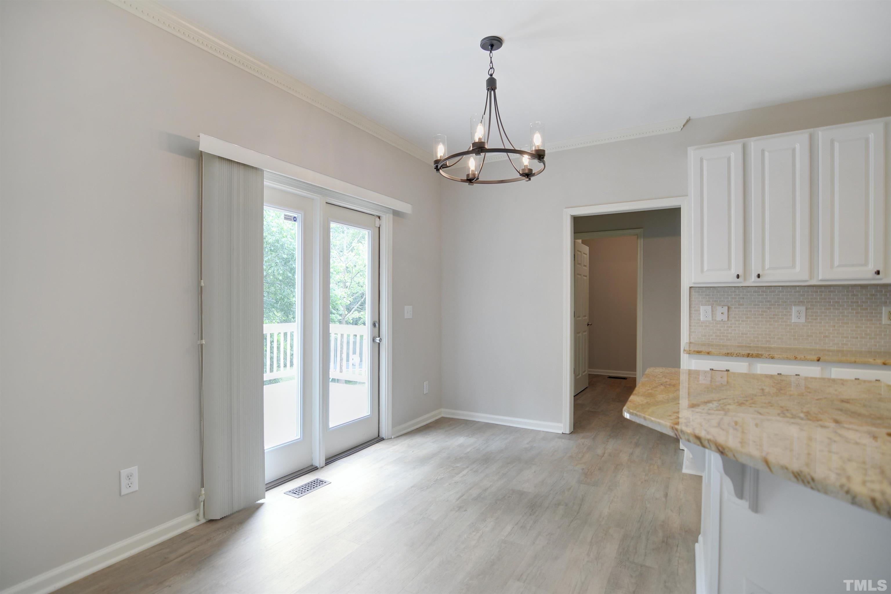 8400 Astwell Court Raleigh, NC 27615 - Photo 7 of 21 a view of a kitchen with stainless steel appliances granite countertop cabinets and a counter top space