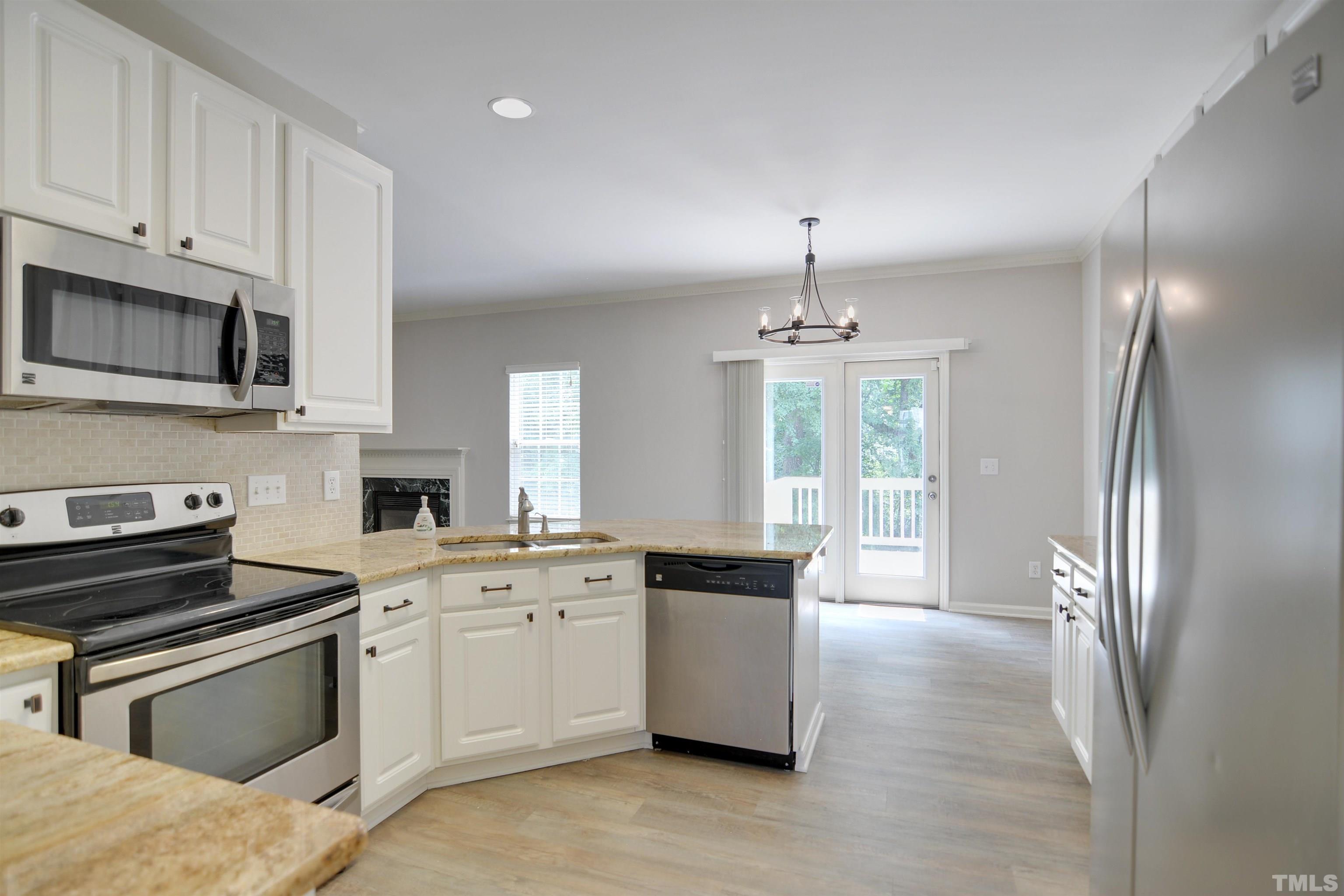 8400 Astwell Court Raleigh, NC 27615 - Photo 9 of 21 a kitchen with stainless steel appliances granite countertop a stove a sink and a refrigerator