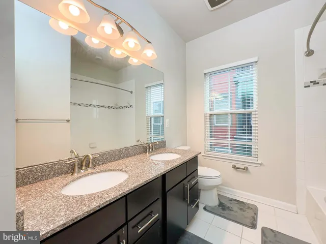 a bathroom with a granite countertop tub a sink and a granite counter tops