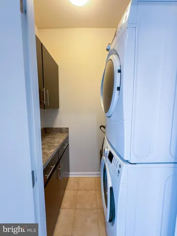 a white toilet sitting next to a white wall