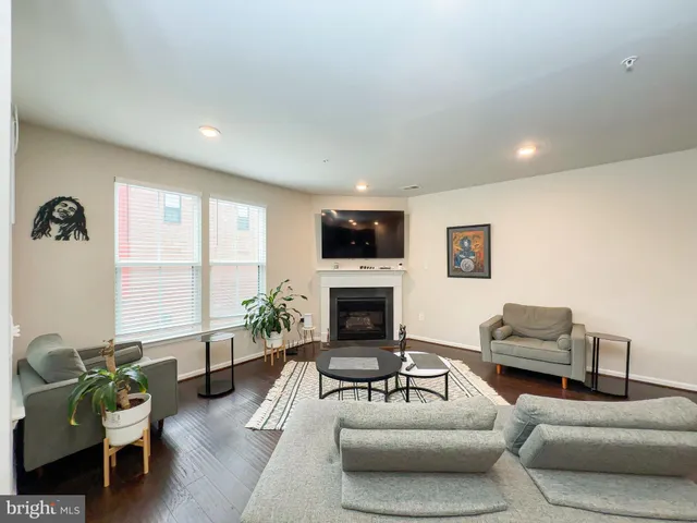 a living room with furniture fireplace and a large window