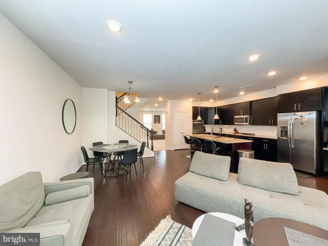 a living room with furniture and kitchen view