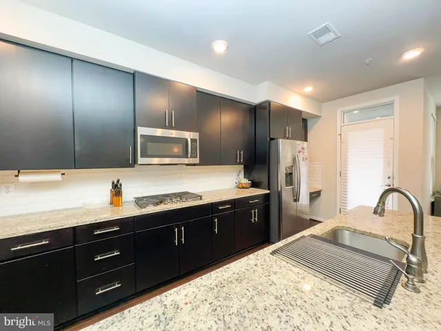 a spacious bathroom with a sink and a large mirror