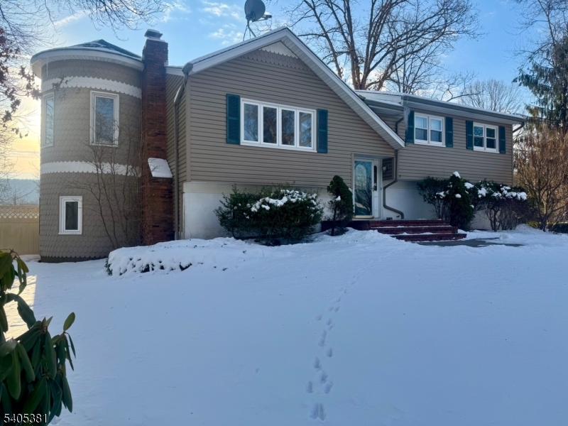 9 Windsor Drive Oak Ridge, NJ 07438 - Photo 2 of 50 a front view of a house with a yard
