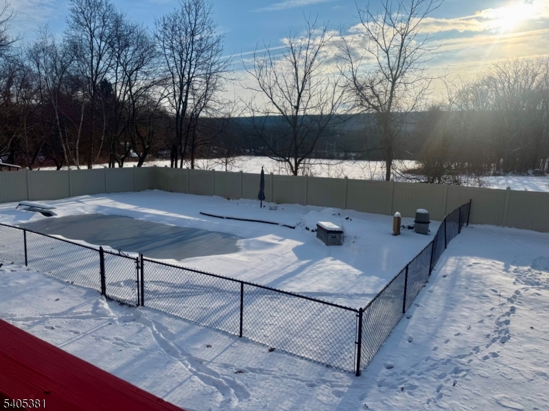 9 Windsor Drive Oak Ridge, NJ 07438 - Photo 23 of 50 a view of a terrace with chairs and wooden fence