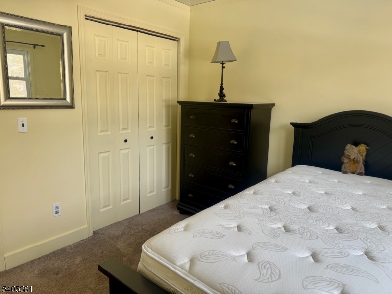 9 Windsor Drive Oak Ridge, NJ 07438 - Photo 26 of 50 a bedroom with a bed and a table