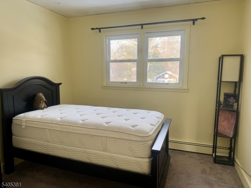 9 Windsor Drive Oak Ridge, NJ 07438 - Photo 27 of 50 a bedroom with a bed and a window