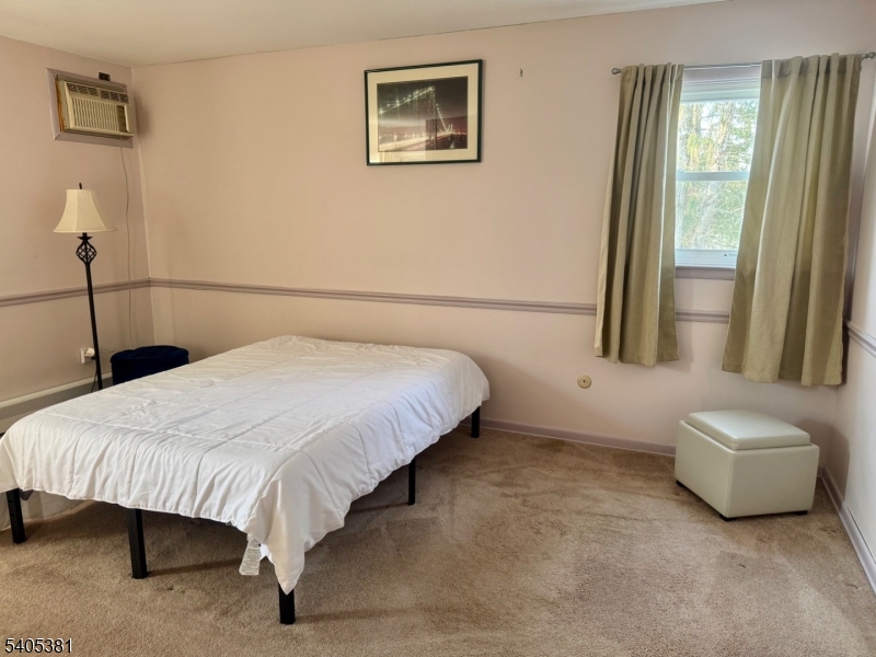 9 Windsor Drive Oak Ridge, NJ 07438 - Photo 30 of 50 a bedroom with a bed and a large window