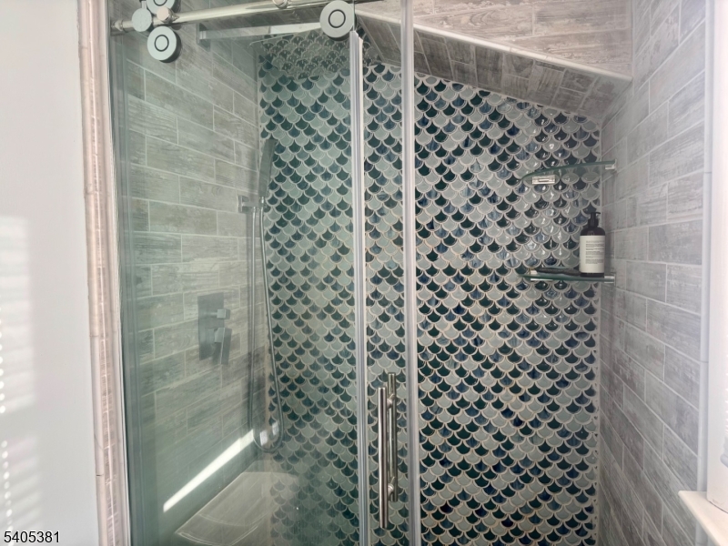 9 Windsor Drive Oak Ridge, NJ 07438 - Photo 33 of 50 a bathroom with a shower curtain