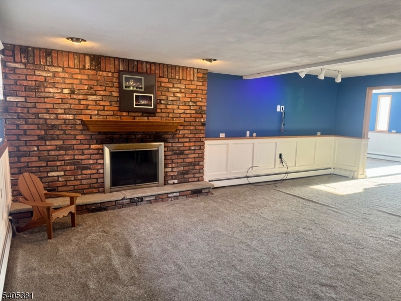 9 Windsor Drive Oak Ridge, NJ 07438 - Photo 35 of 50 a view of an empty room with a fireplace and a window