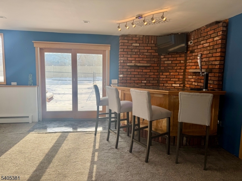 9 Windsor Drive Oak Ridge, NJ 07438 - Photo 43 of 50 a view of a dining room with furniture and a window