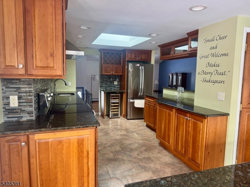 9 Windsor Drive Oak Ridge, NJ 07438 - Photo 47 of 50 a kitchen with stainless steel appliances granite countertop wooden cabinets a sink and dishwasher