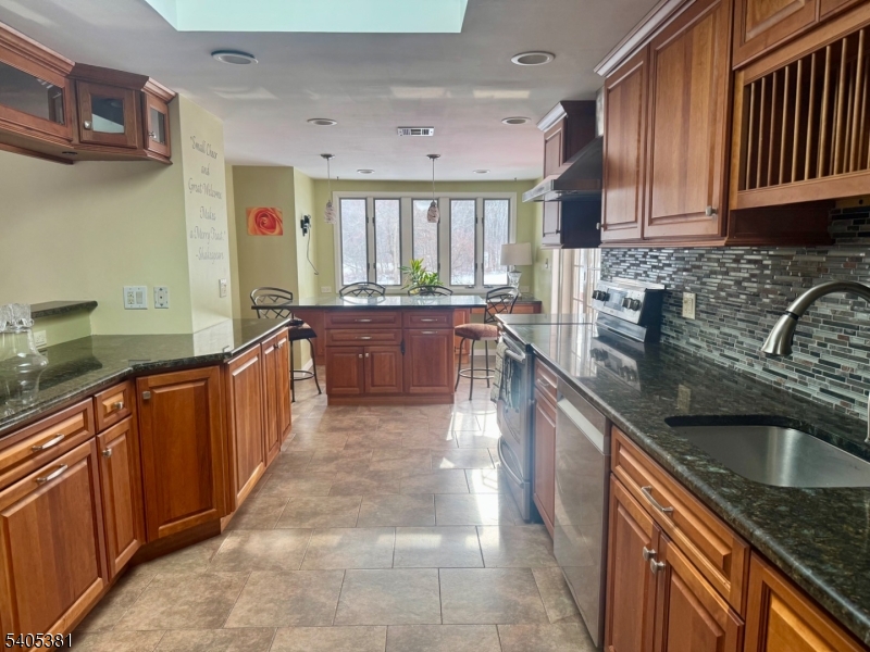 9 Windsor Drive Oak Ridge, NJ 07438 - Photo 50 of 50 a large kitchen with stainless steel appliances granite countertop a sink stove and cabinets