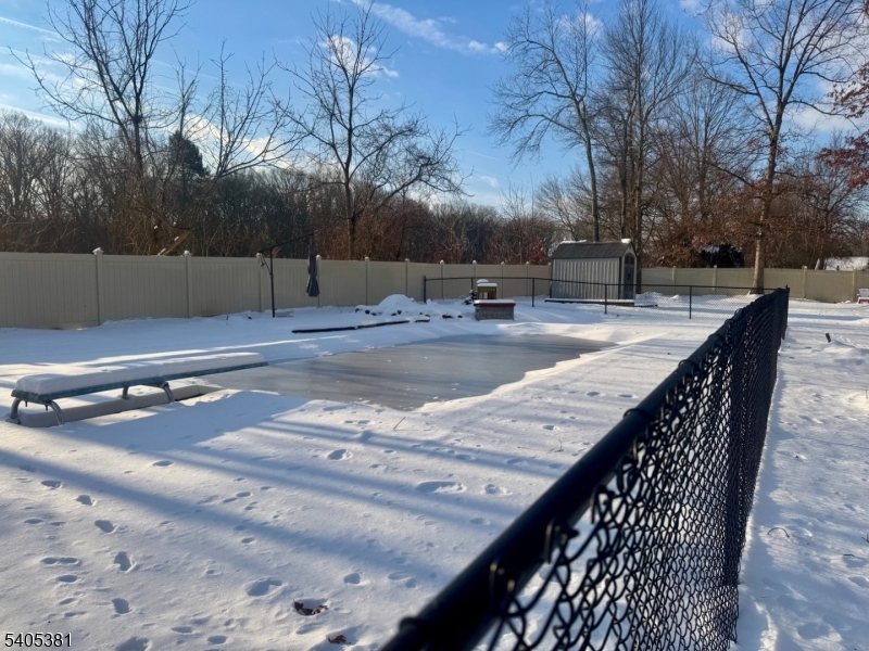 9 Windsor Drive Oak Ridge, NJ 07438 - Photo 5 of 50 a view of a backyard with snow