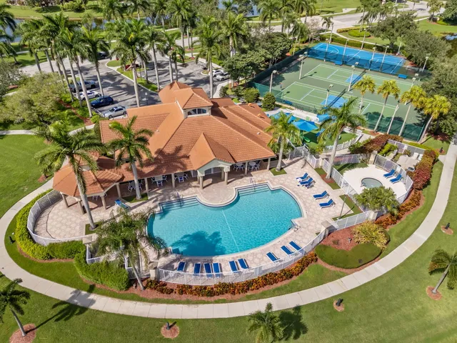 a view of a swimming pool with a yard and seating