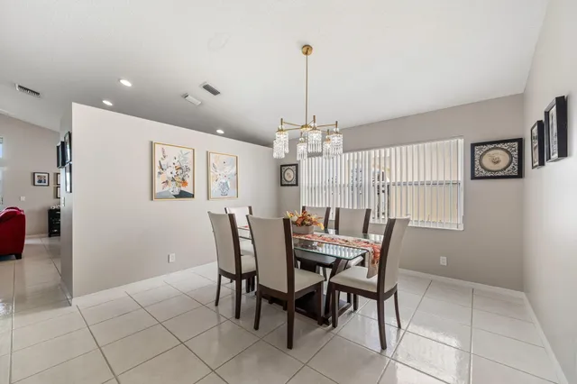 a view of a dining room with furniture and chandelier