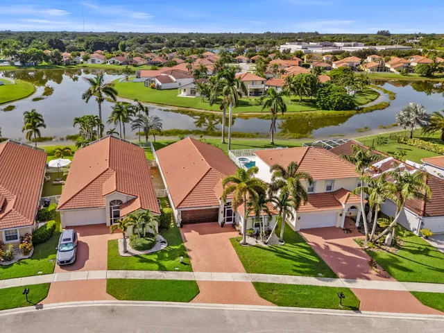 an aerial view of residential houses with outdoor space and river
