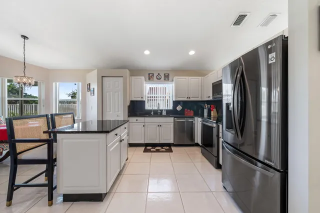 a kitchen with stainless steel appliances a refrigerator sink and cabinets