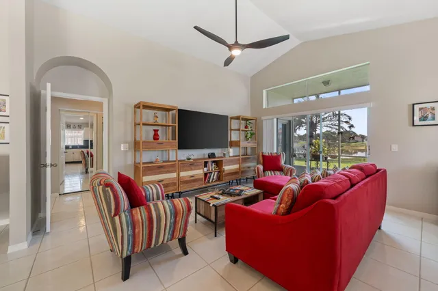 a living room with furniture a flat screen tv and a window