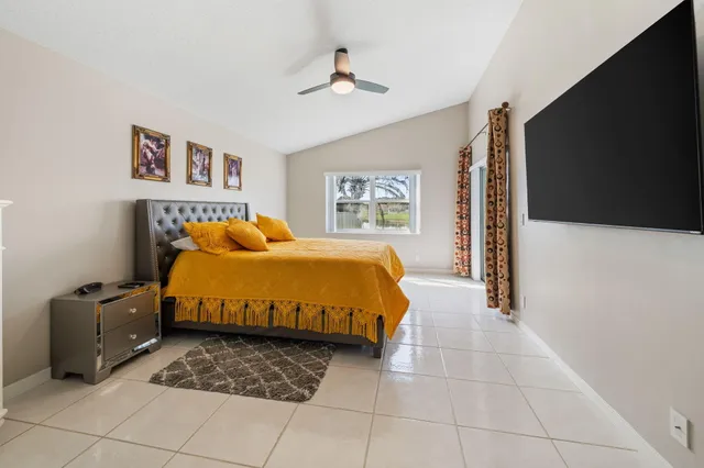 a bedroom with a bed and a television