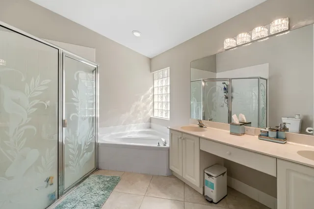 a bathroom with a tub a sink shower and a mirror