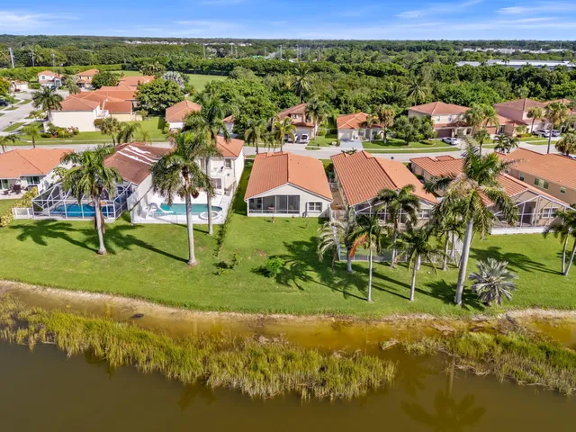 an aerial view of residential houses with outdoor space and street view