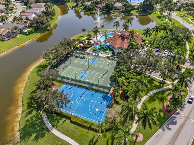 an aerial view of a house with a garden and lake view