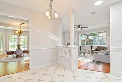 a living room with fireplace furniture and floor to ceiling window