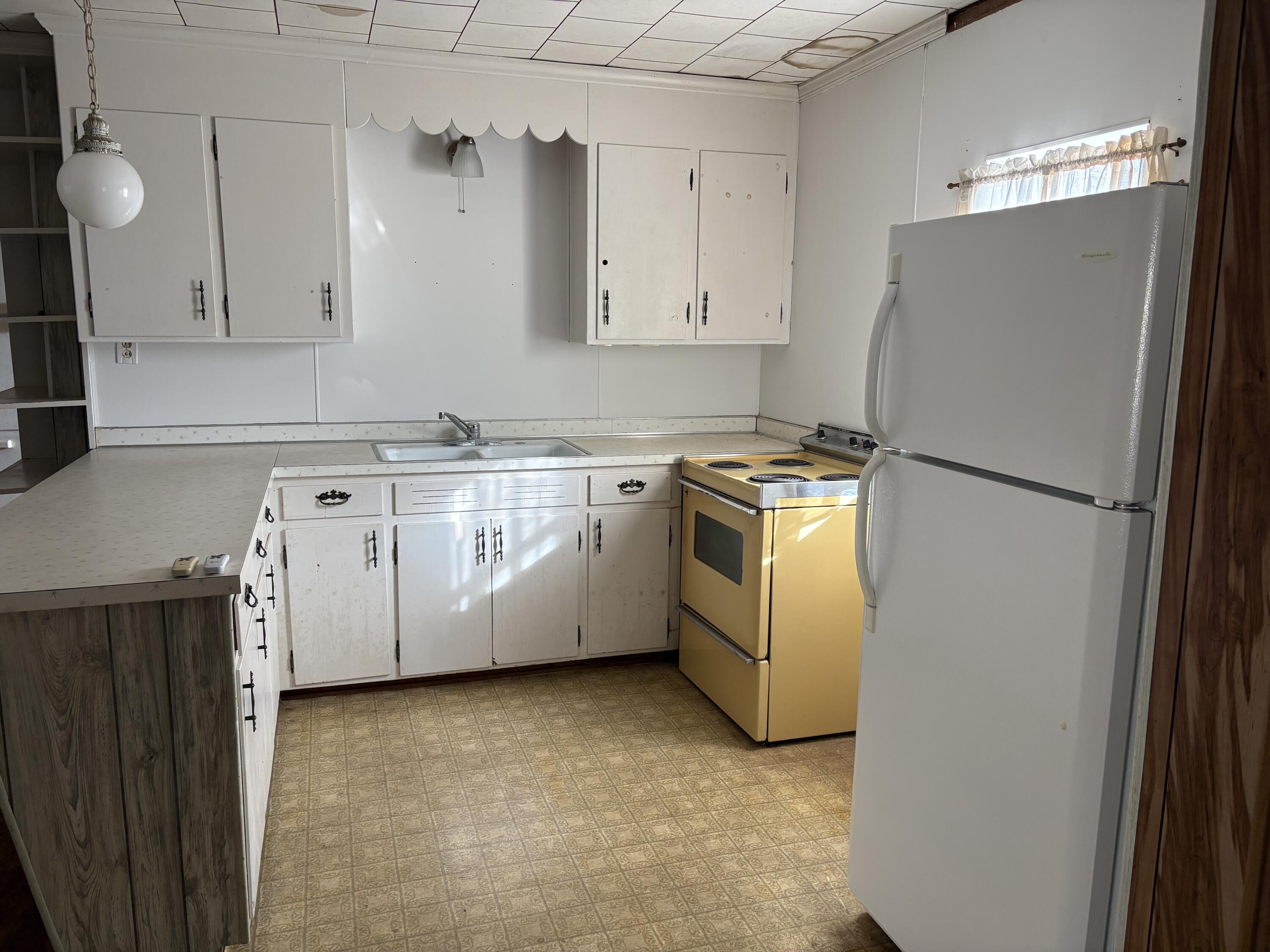 197 Cobb Road Panama City Beach, FL 32413 - Photo 12 of 18 a utility room with cabinets washer and dryer