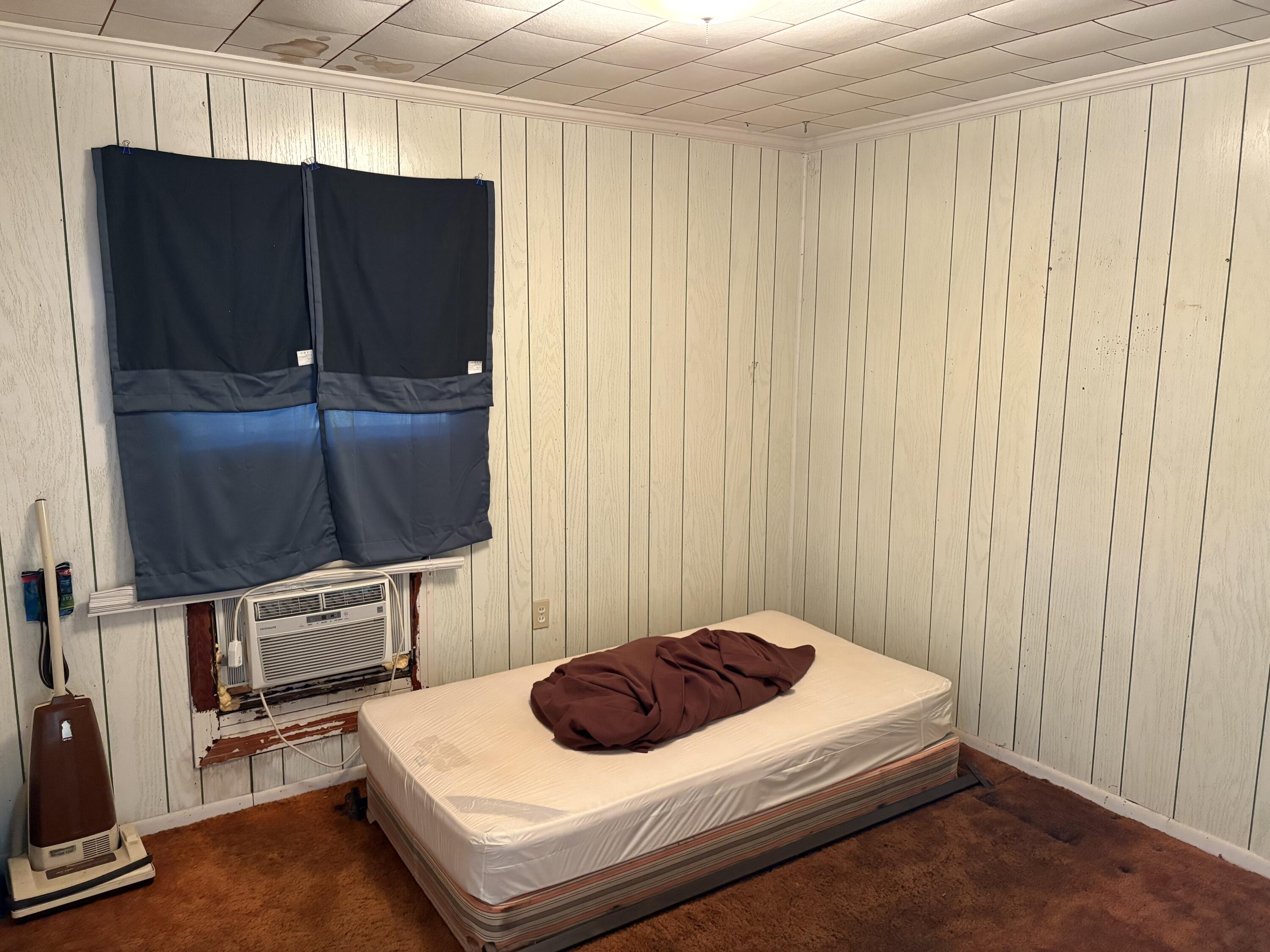 197 Cobb Road Panama City Beach, FL 32413 - Photo 17 of 18 a bedroom with a bed and furniture