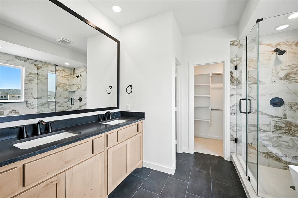 4520 Script Street Prosper, TX 75078 - Photo 16 of 27 a bathroom with a shower sink and mirror
