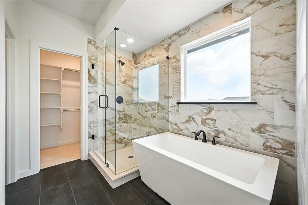 4520 Script Street Prosper, TX 75078 - Photo 17 of 27 a bathroom with a tub a sink and a shower